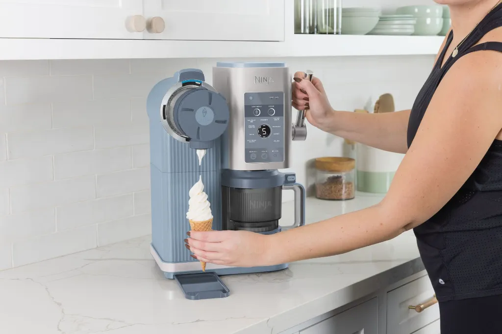 JPG-R_NC702EU_InUse_Kitchen_OnCounter_Dispensing_Woman3.webp
